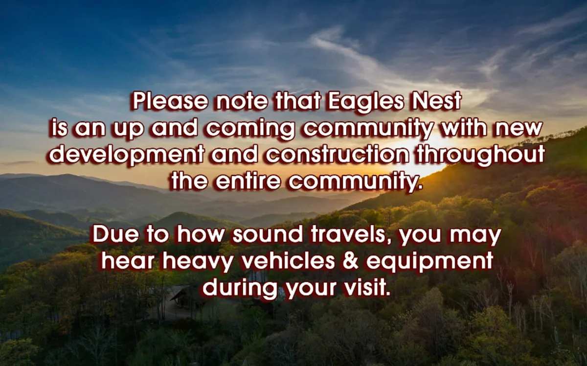 A breathtaking panoramic view of a mountain range at sunset, with a lush valley below and a brilliant sky overhead. The scene invites exploration and captures the essence of the natural beauty surrounding Eagles Nest.